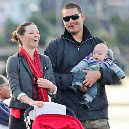 Evangeline Lilly laughing while Norman Kali holding their baby